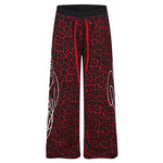 High-street red and black leopard pattern wide-leg joggers with gothic graphic detail