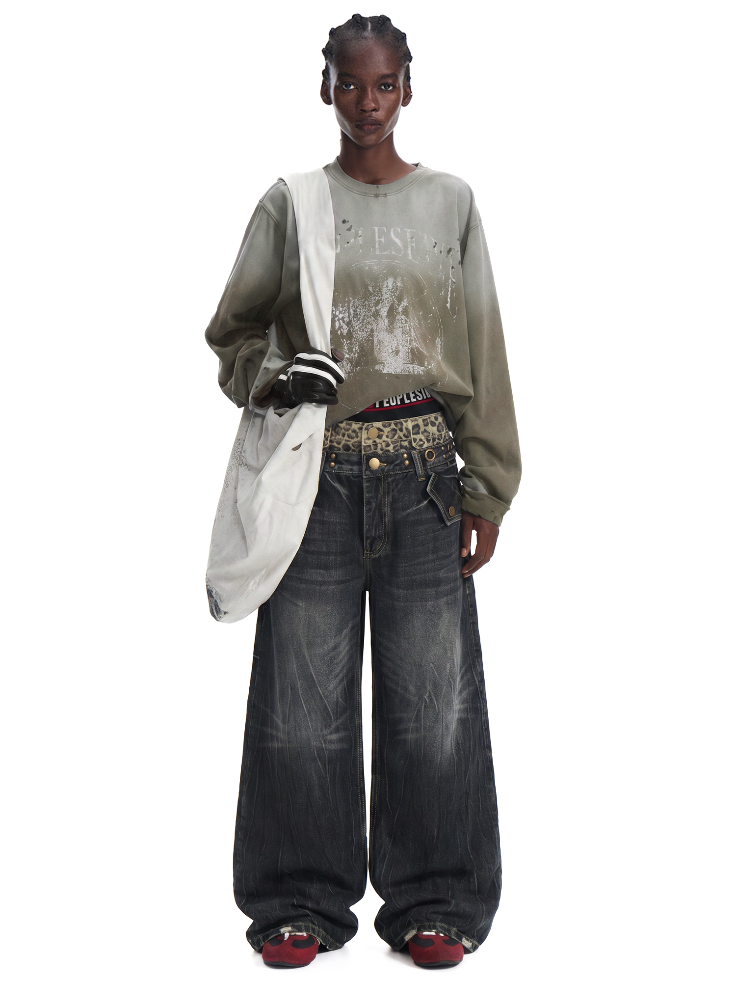 Front view of a model wearing dark charcoal wash wide-leg jeans with a long-sleeve grey top and white shoulder bag.