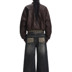 Back view of a model wearing dark wash baggy jeans and a brown leather jacket, showing the oversized fit and back pocket detail.