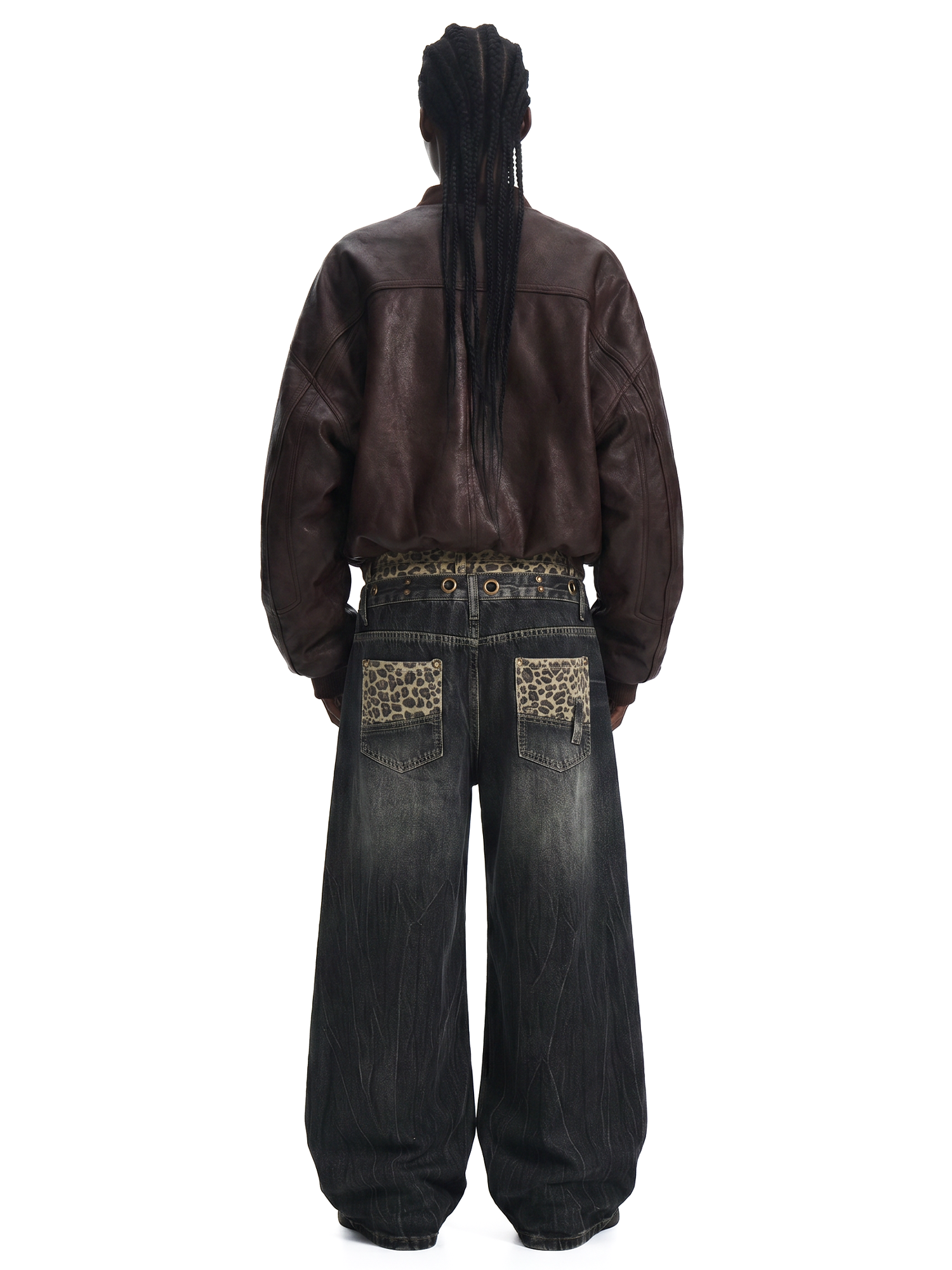 Back view of a model wearing dark wash baggy jeans and a brown leather jacket, showing the oversized fit and back pocket detail.