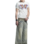 Full-length front view of a model styled in wide-leg light blue distressed jeans and a white graphic tee.
