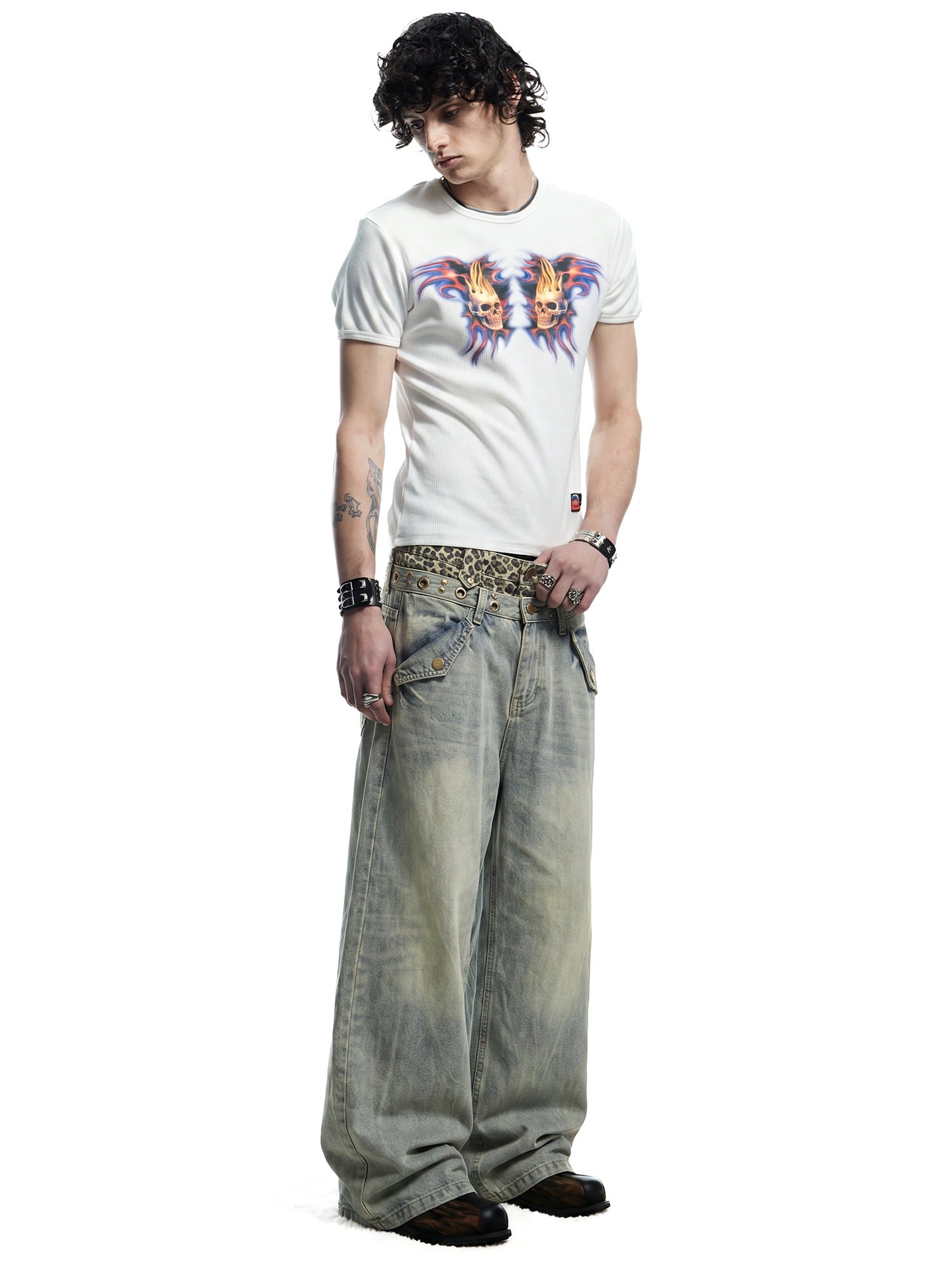 Full-length front view of a model styled in wide-leg light blue distressed jeans and a white graphic tee.
