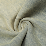 Close-up texture shot of light wash denim fabric showing the weave and subtle distressing.