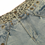 Three-quarter side view of light blue oversized jeans highlighting the baggy silhouette and layered waist design.
