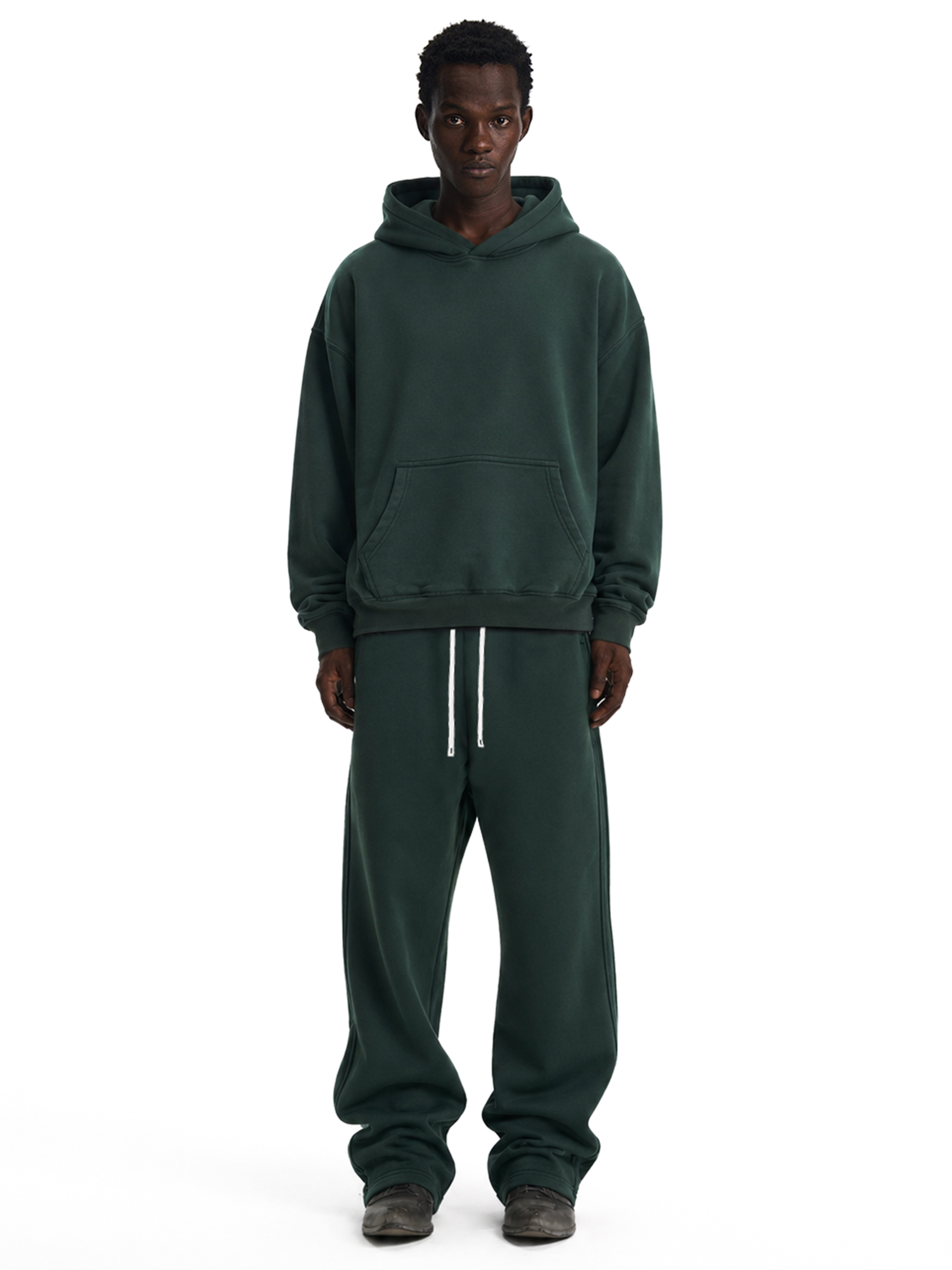 Male model in dark green heavyweight hoodie and straight-leg sweatpants set