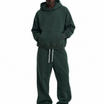 Side view of dark green hoodie set with hands in pockets