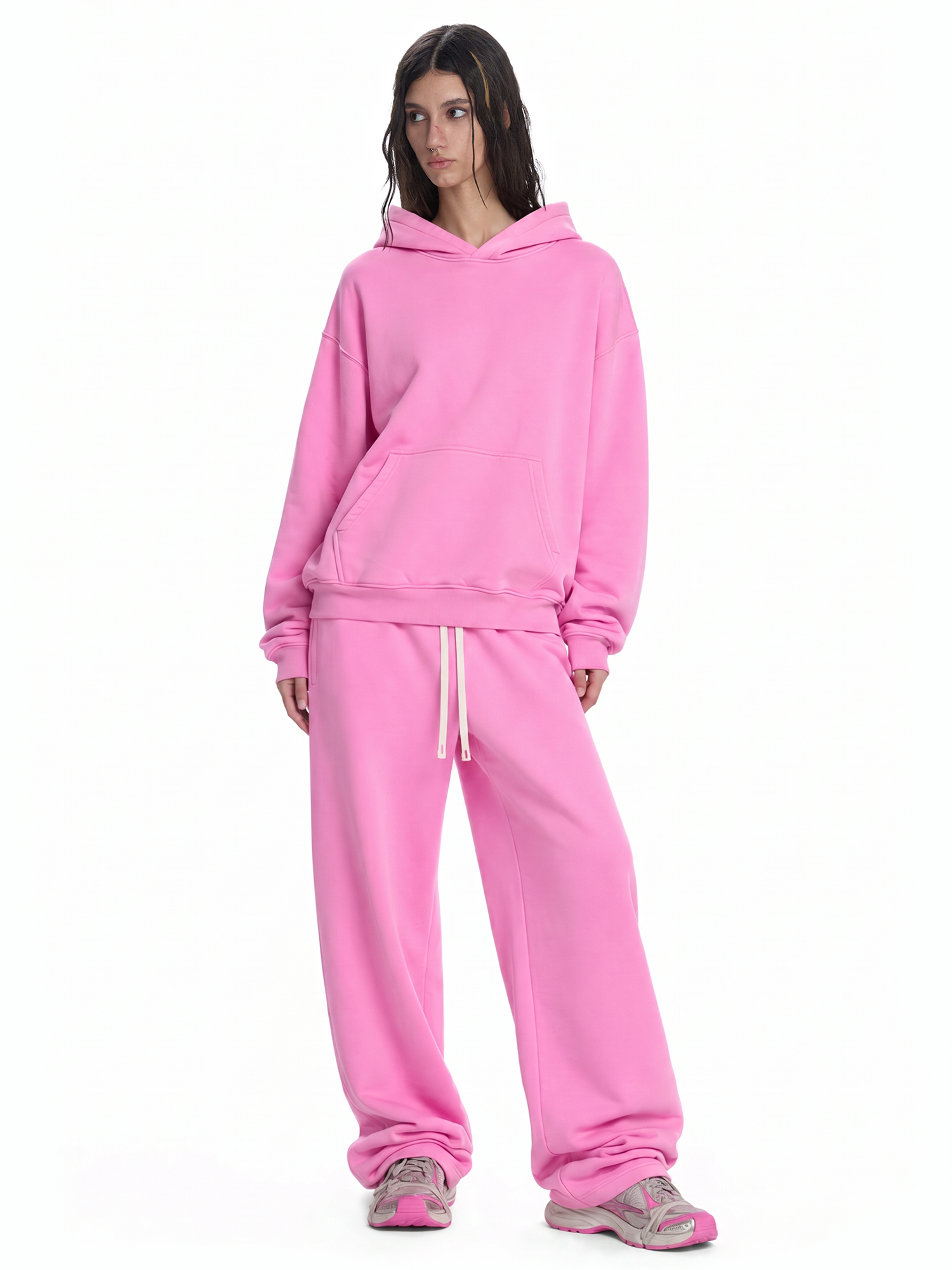 Woman wearing vibrant pink oversized streetwear tracksuit