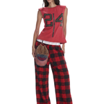 Female model wearing red plaid baggy pants with a cropped top for a Y2K streetwear look.