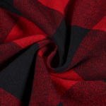 Close-up of premium cotton-blend red and black checkered fabric for durable streetwear wear.