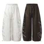 Comparison of oversized wide-leg sweatpants in both white and dark brown colors.
