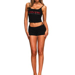 Full front view of women's black streetwear two-piece outfit with red graphic tank top.