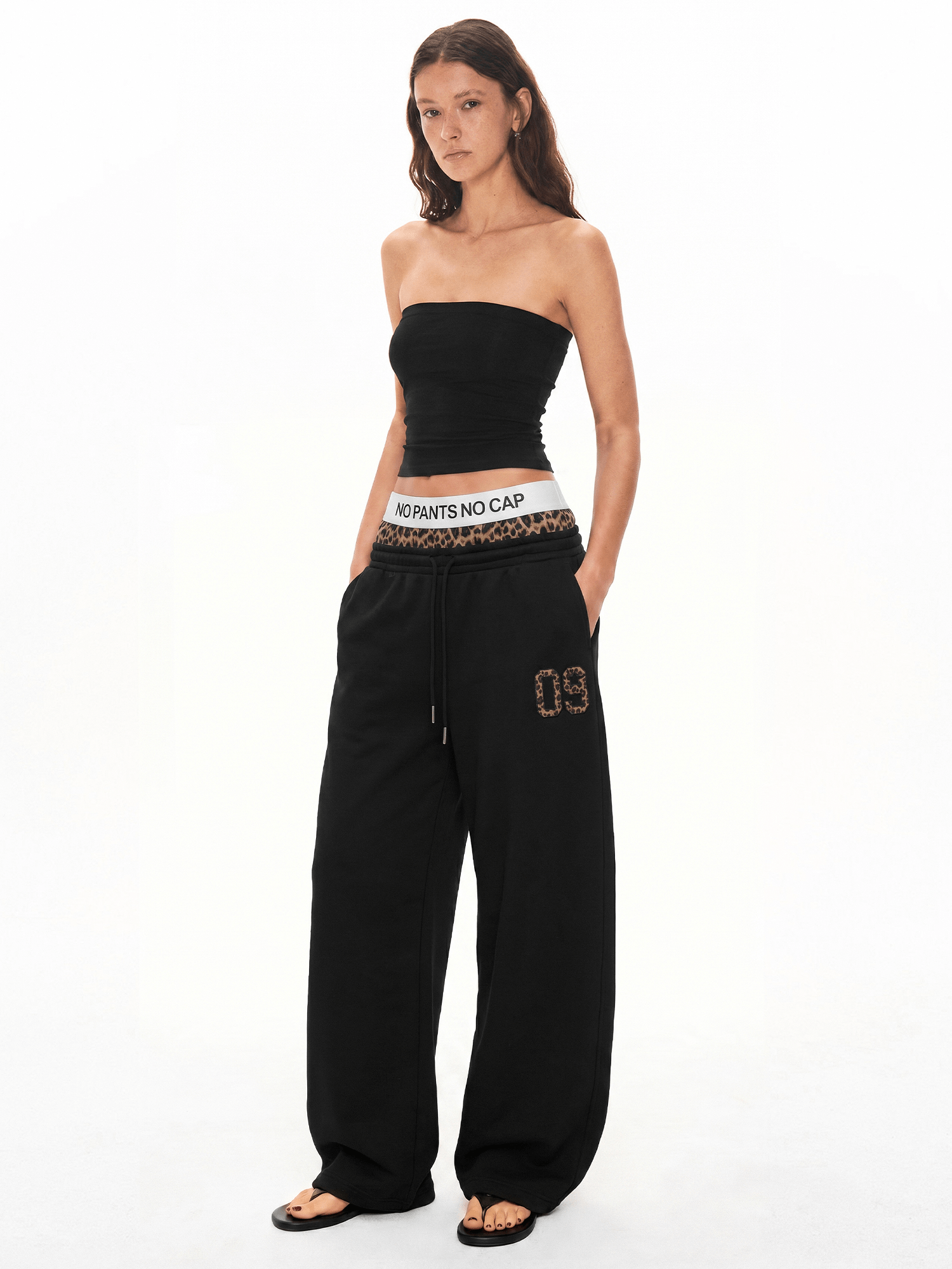 Front view of model wearing Slogan Layered Leopard Sweatpants in Black - FDR