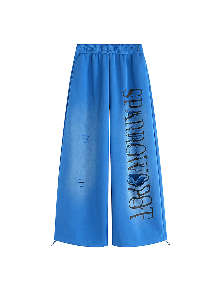 Pantalons de survêtement à jambe large bleu électrique de FDR Studios, ornés d’une impression graphique noire, style cyber Y2K de la grande rue