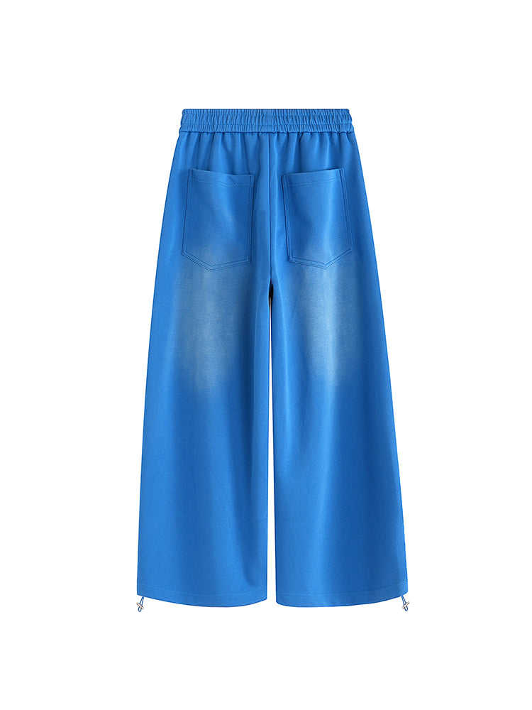 Minimalist back design of FDR Studios blue baggy trousers for unisex streetwear outfits.