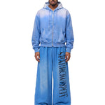 Male model wearing FDR Studios blue techwear full-zip hoodie and oversized joggers.
