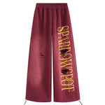 FDR Studios burgundy wide-leg joggers with yellow graphic embroidery, techwear inspired streetwear pants.