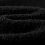 Close-up of dark textured fabric with a focus on pattern and texture.
