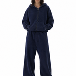 Full body view of a navy blue oversized zip-up hoodie and matching wide-leg sweatpants set on a model.