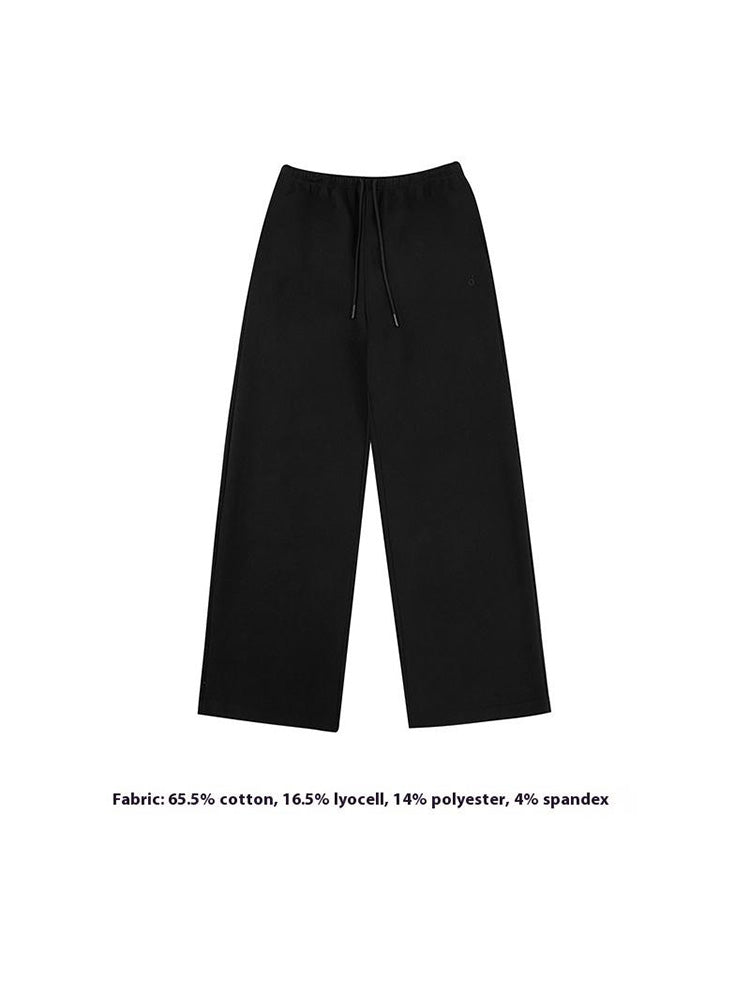 Minimalistische Flat-Lay-Produktaufnahme der FDR Studios industrielschwarzen weit geschnittenen Jogginghosen mit verstellbarem Kordelzug am Taillenbund und klaren Linien. Ein unverzichtbares Stück für minimalistischen Techwear.