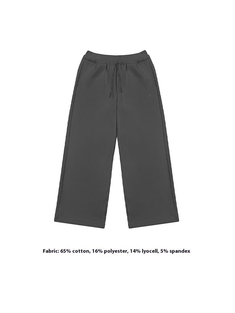 A close-up shot of light dary grey wide-leg sweatpants, focusing on the pocket details and the soft, textured Lyocell-blend fabric. A key feature for premium women's loungewear.