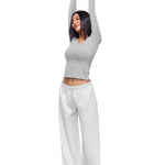 Side profile shot of a model in FDR Studios Heather Grey wide-leg sweatpants, highlighting the relaxed, high-waisted fit and premium soft fabric texture. Ideal for both home and streetwear.