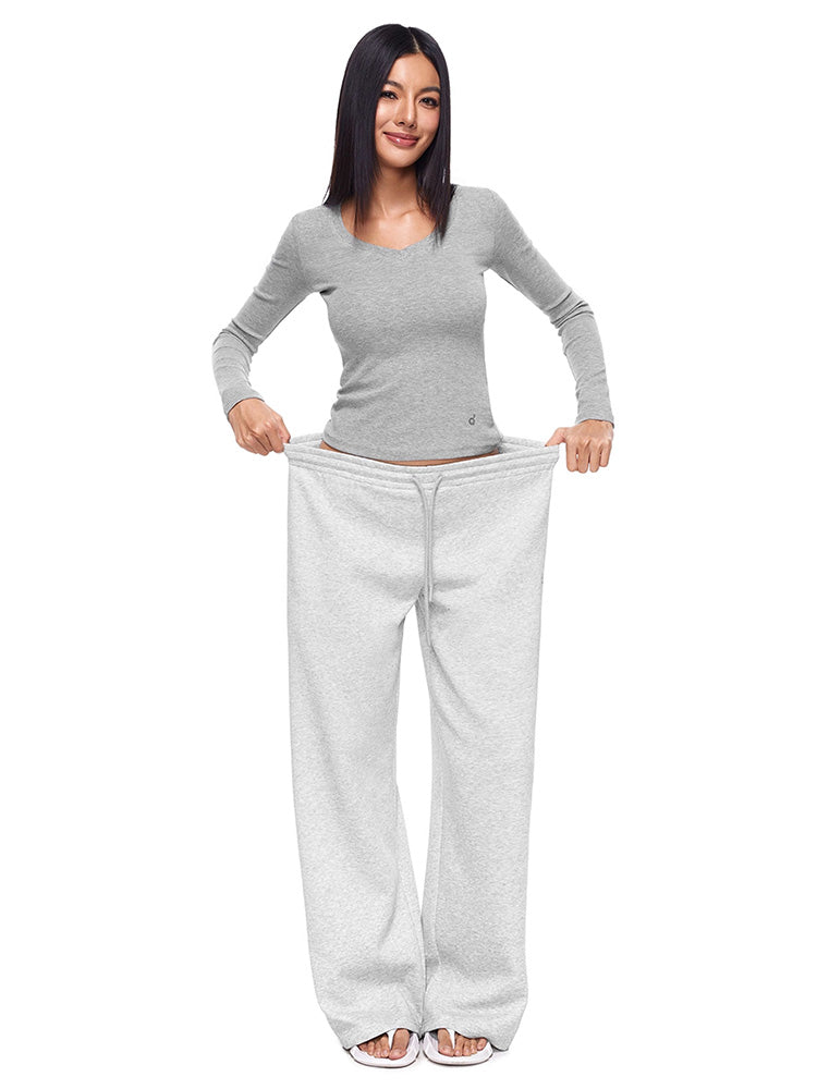 Full-body photo of a model showcasing the Heather Grey variant of FDR Studios wide-leg sweatpants, paired with a matching long-sleeve crop top. A versatile and breathable women's loungewear essential.