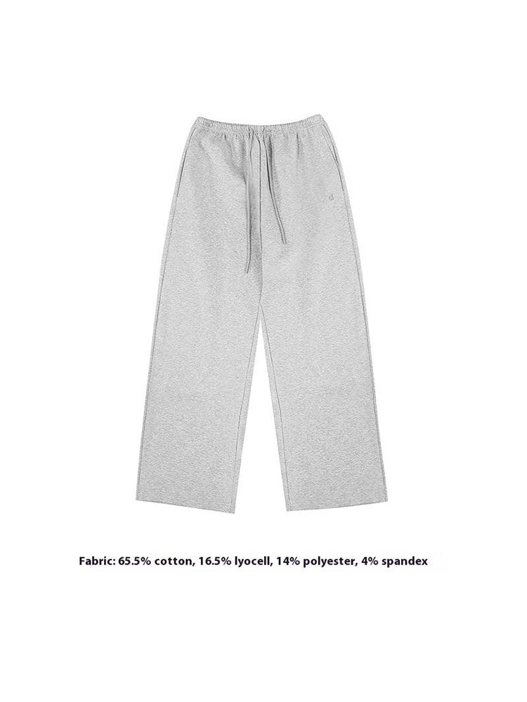A neat flat-lay presentation of light grey wide-leg sweatpants, showing the drawstring waist and clean finish of these premium women's casual trousers.