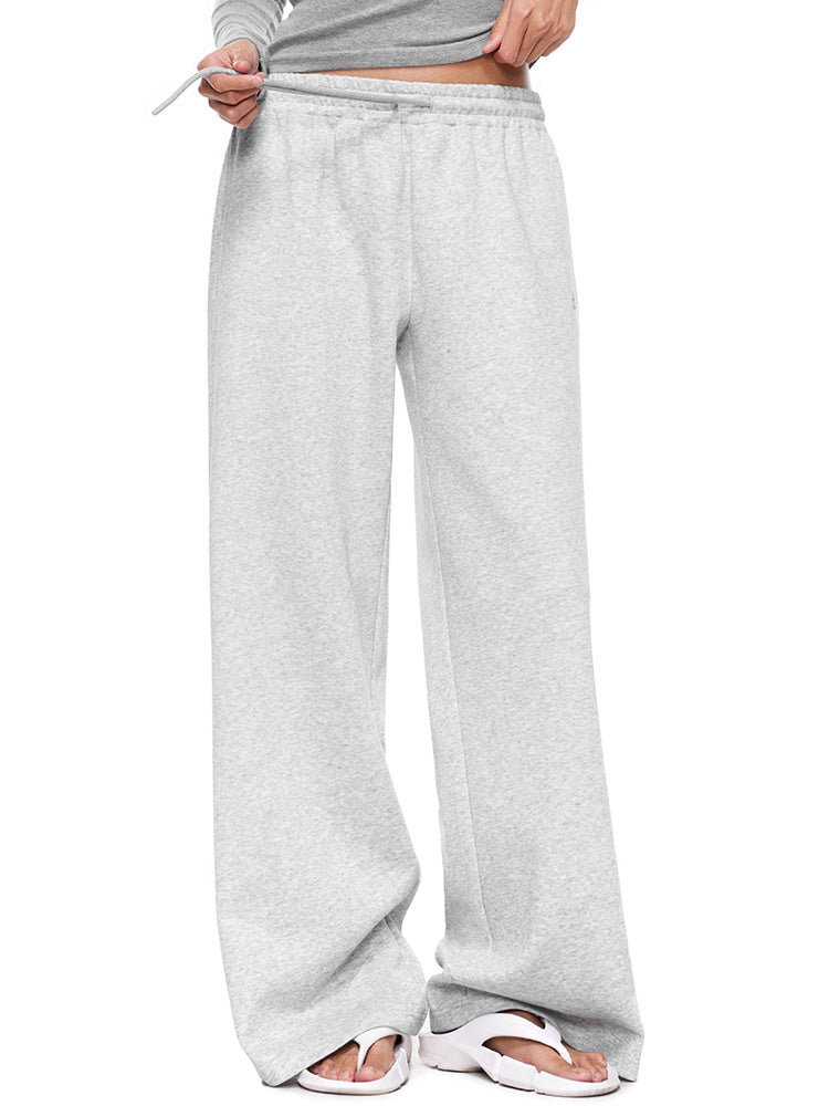 Full-body shot of a female model wearing light grey wide-leg sweatpants, showcasing a classic women's casual trousers fit for comfortable everyday wear.