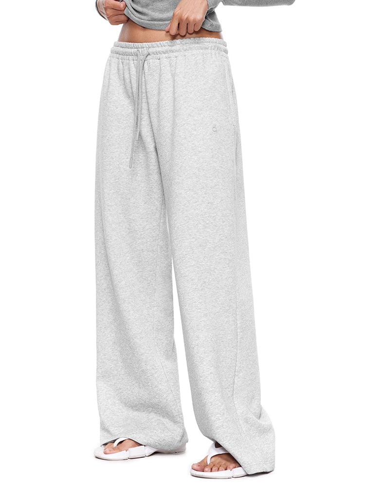 Side view of a model in light grey wide-leg sweatpants, illustrating the relaxed fit and clean, modern silhouette of these soft loungewear trousers.