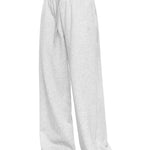 Side view of a model in light grey wide-leg sweatpants, illustrating the relaxed fit and clean, modern silhouette of these soft loungewear trousers.