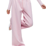 A direct front view of a model showcasing the complete FDR Studios soft pink wide-leg sweatpants set. Highlighting the comfort and clean silhouette of this versatile loungewear.