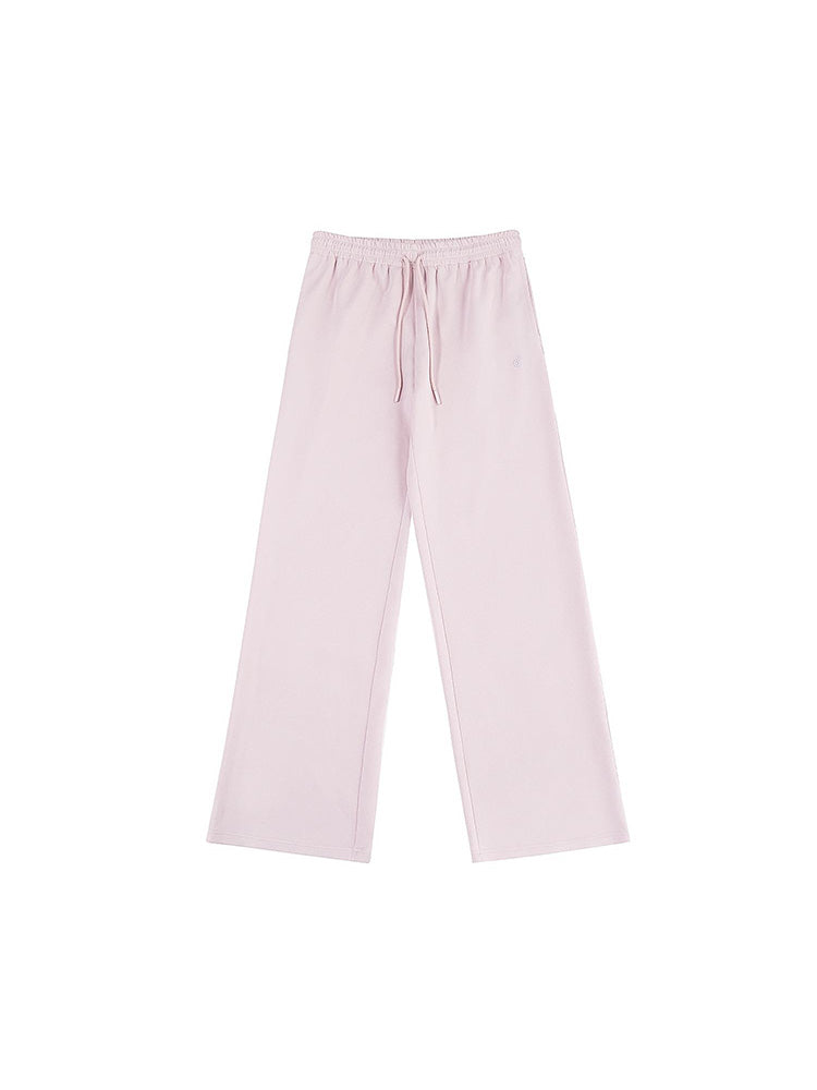 A simple flat-lay image of soft pink wide-leg sweatpants, featuring an adjustable drawstring waist. A stylish and comfortable option for modern women's loungewear collections.
