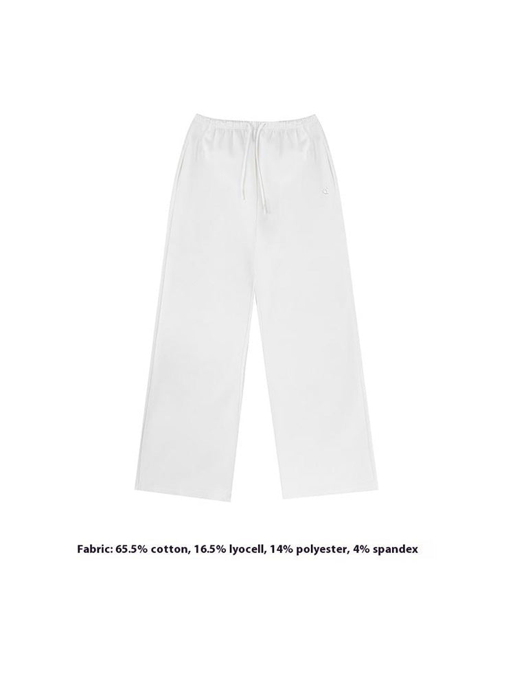 A classic flat-lay product image of crisp white wide-leg sweatpants, showcasing the adjustable drawstring waist and clean finish of this essential women's trousers style.