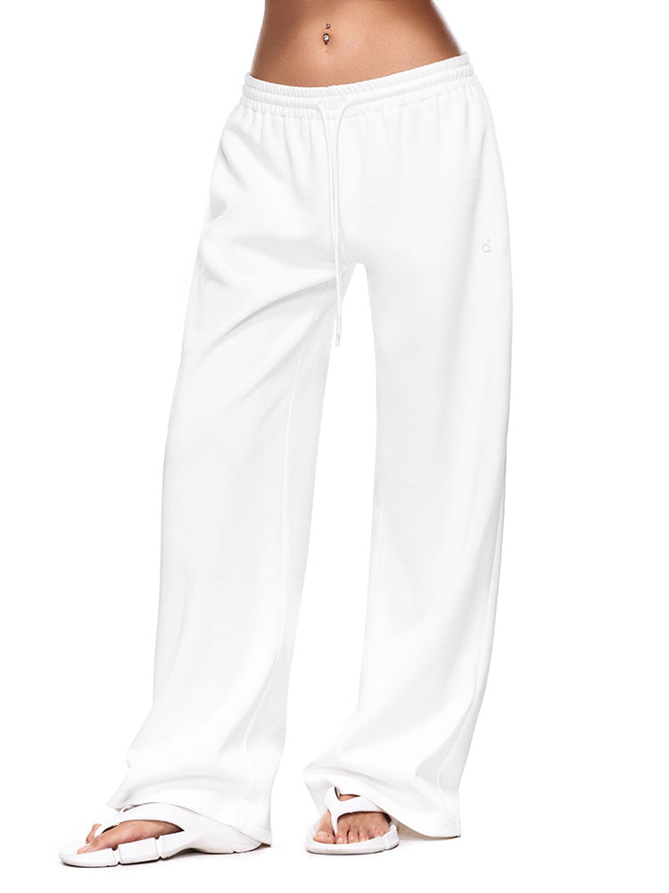 Full-body shot of a model wearing crisp white wide-leg sweatpants  illustrating a clean, minimal loungewear pants with a relaxed, premium feel.