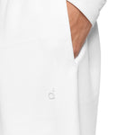 Full-body shot of a model wearing crisp white wide-leg sweatpants with pocket detail