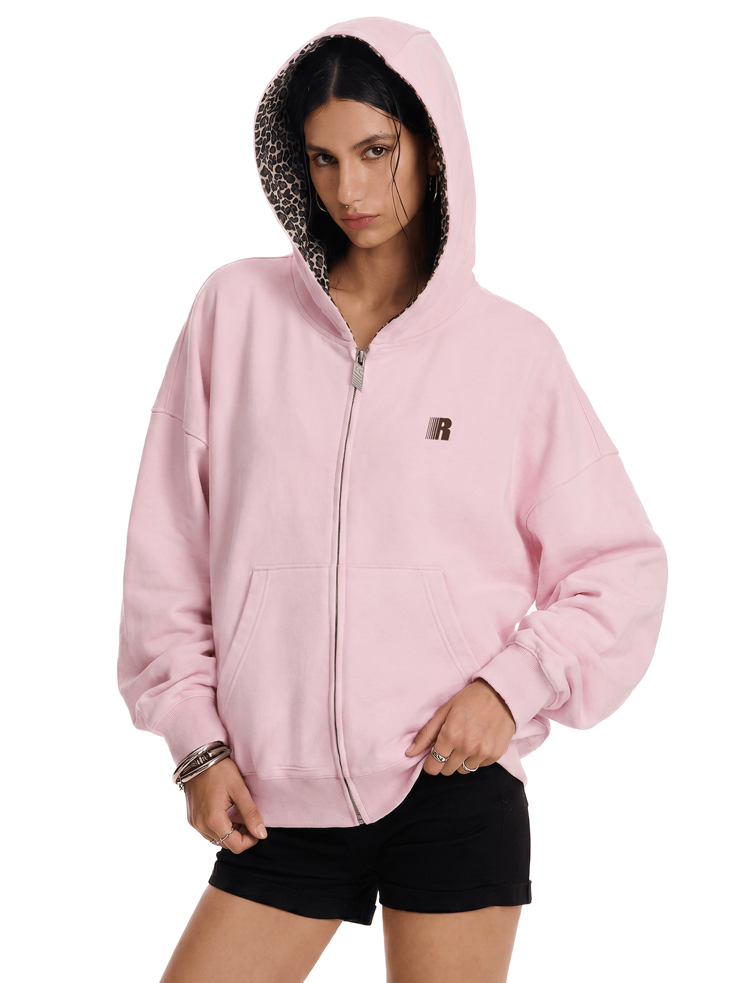 Person wearing a pink hoodie with a leopard print hood on a white background
