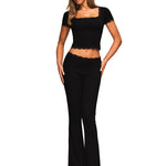 Studio shot of a woman in a black lace-trimmed ribbed set showing the slim fit silhouette.