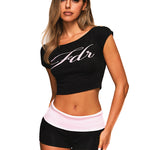 Front view of a model wearing a black FDR off-shoulder crop top with white script logo.