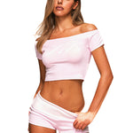 Close-up detail of the pink FDR crop top showing the off-the-shoulder neckline and ribbed fabric.