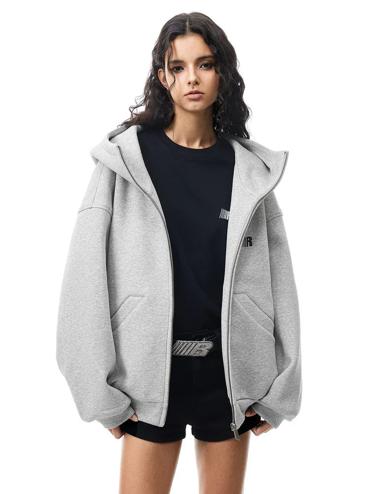 Multiple angles of model in grey high-neck hoodie, showcasing structured fabric and minimalist design.