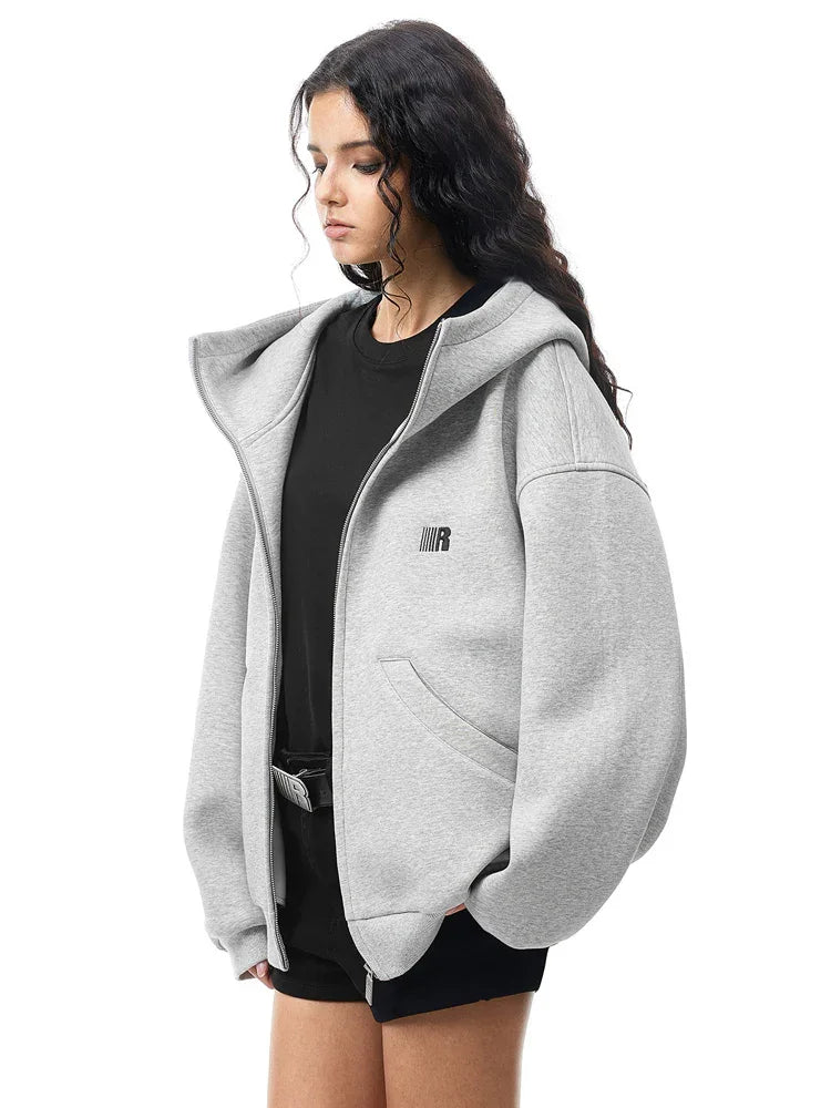 Multiple angles of model in grey high-neck hoodie, showcasing structured fabric and minimalist design.