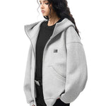 Multiple angles of model in grey high-neck hoodie, showcasing structured fabric and minimalist design.