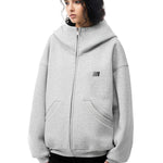 Multiple angles of model in grey high-neck hoodie, showcasing structured fabric and minimalist design.
