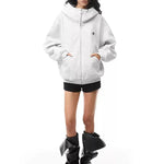 Model wearing light gray structured hoodie, presenting a bright Y2K high-street fashion look.