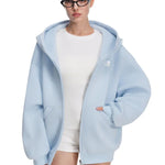 Model posing in light blue hoodie, highlighting the oversized hood and soft fabric drape.