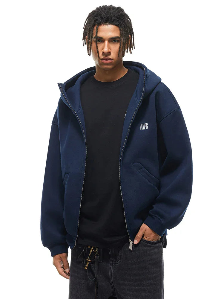 Half-zipped navy blue hoodie on model, showcasing layering versatility and clean hardware details.