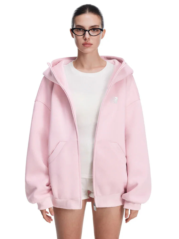 Side view of pink baggy hoodie on model, showcasing dropped shoulders and loose silhouette.