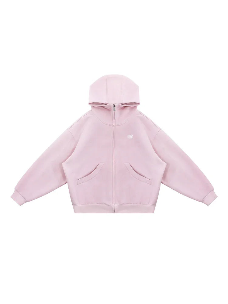 Flat lay of pastel pink oversized zip hoodie on white background, showing product shape and hardware.