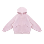 Flat lay of pastel pink oversized zip hoodie on white background, showing product shape and hardware.