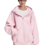 Front view of model wearing pastel pink oversized zip-up hoodie, perfect for spring/summer streetwear.